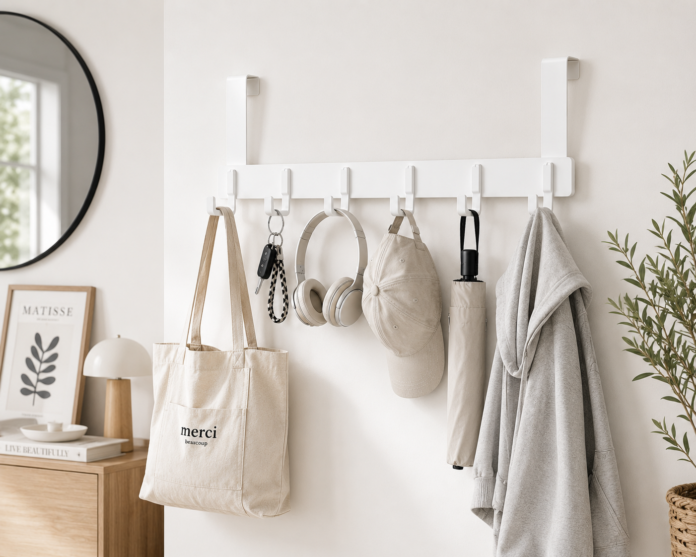 White over-the-door hook rack holding a bag, headphones, hat and jacket